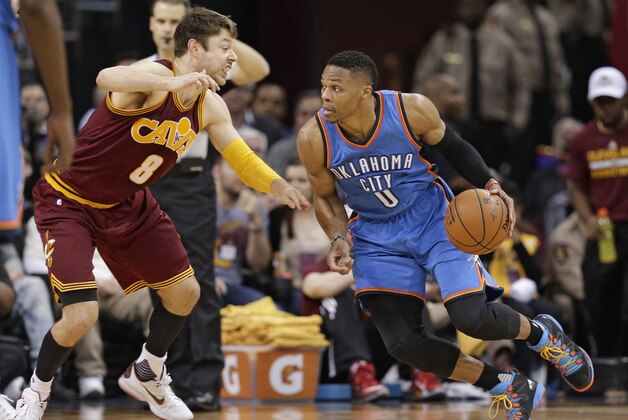 Oklahoma City Thunder’s Russell Westbrook (0) drives past Cleveland Cavaliers' Matthew Dellavedova (8), from Australia, in the first half of an NBA basketball game Thursday, Dec. 17, 2015, in Cleveland. (AP Photo/Tony Dejak)