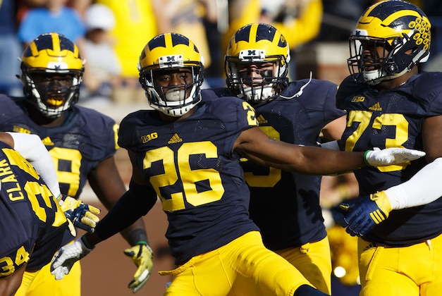Oct 10, 2015; Ann Arbor, MI, USA; Michigan Wolverines cornerback Jourdan Lewis (26) celebrates with teammates after he scores a touchdown on an interception in the second quarter against the Northwestern Wildcats at Michigan Stadium. Mandatory Credit: Rick Osentoski-USA TODAY Sports