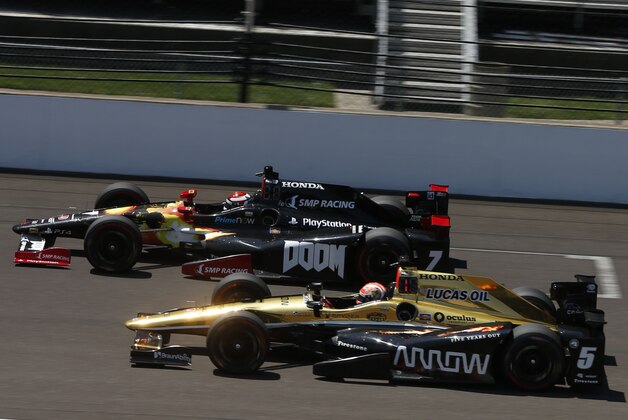 May 23, 2016; Indianapolis, IN, USA; Verizon Indy Car driver James Hinchcliffe (5) and Mikhail Aleshin (7) race side by side down the front straightaway during practice for the Indianapolis 500 at Indianapolis Motor Speedway. Mandatory Credit: Brian Spurlock-USA TODAY Sports