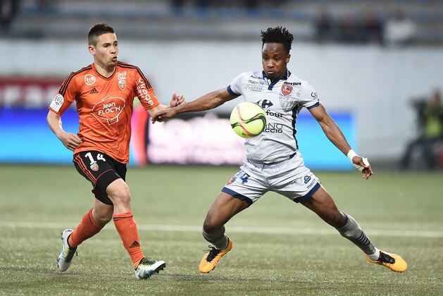 Lorient's French defender Raphael Guerreiro (L) vies with Ajaccio's Congolese forward John Tshibumbu during the French Ligue 1 football match between Lorient and Ajaccio on May 14, 2016 at the Moustoir stadium in Lorient, western France. AFP PHOTO / JEAN-SEBASTIEN EVRARD / AFP / JEAN-SEBASTIEN EVRARD        (Photo credit should read JEAN-SEBASTIEN EVRARD/AFP/Getty Images)