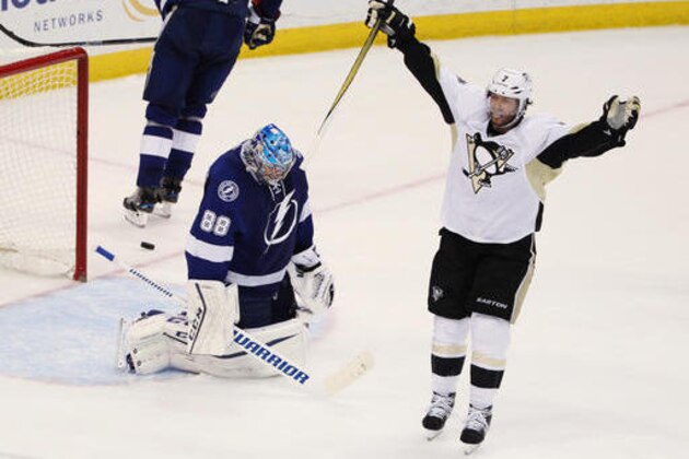 Pittsburgh Penguins center Matt Cullen (7) celebrates a goal by teammate Sidney Crosby (87), as Tampa Bay Lightning goalie Andrei Vasilevskiy (88), of Russia, remains kneeling on the ice, during the second period of Game 6 of the NHL hockey Stanley Cup Eastern Conference finals Tuesday, May 24, 2016, in Tampa, Fla. (AP Photo/Brian Blanco)