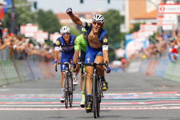 Italy's rider Matteo Trentin celebrates as he crosses the finish line to win the 18th stage of the 99th Giro d'Italia, Tour of Italy, from Muggio to Pinerolo on May 26, 2016.  AFP PHOTO / LUK BENIES / AFP / LUK BENIES        (Photo credit should read LUK BENIES/AFP/Getty Images)