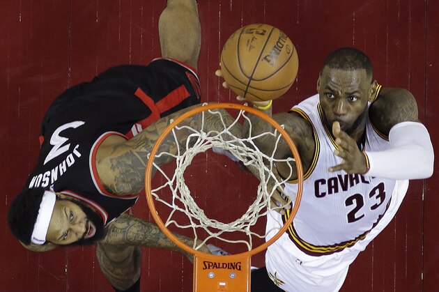 Cleveland Cavaliers' LeBron James (23) shoots against Toronto Raptors' James Johnson (3) during the first half of Game 5 of the NBA basketball Eastern Conference finals Wednesday, May 25, 2016, in Cleveland. (AP Photo/Tony Dejak)
