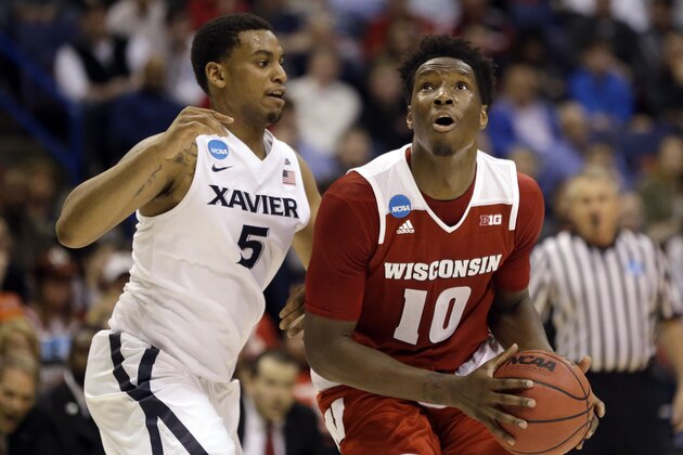 Wisconsin's Nigel Hayes looks to the basket as Xavier's Trevon Bluiett, left, defends during the second half in a second-round men's college basketball game in the NCAA Tournament, Sunday, March 20, 2016, in St. Louis. Wisconsin won 66-63. (AP Photo/Jeff Roberson)
