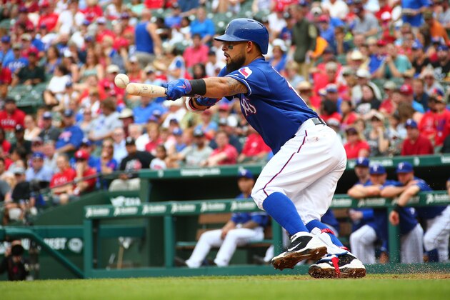 ARLINGTON, TX - MAY 25: Rougned Odor #12 of the Texas Rangers bunts for a base hit in the first inning against the Los Angeles Angels of Anaheim at Global Life Park in Arlington on May 25, 2016 in Arlington, Texas. (Photo by Rick Yeatts/Getty Images)