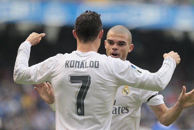 Real Madrid's Cristiano Ronaldo, front, is congratulated by teammate Pepe after scoring the first goal during a Spanish La Liga soccer match between Deportivo and Real Madrid at the Riazor stadium in A Coruna, Spain, Saturday, May 14, 2016. (AP Photo/Lalo R. Villar)