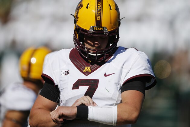 Minnesota Golden Gophers quarterback Mitch Leidner (7) checks plays on his wristband in the third quarter of an NCAA college football game Saturday, Sept. 12, 2015, in Fort Collins, Colo. Minnesota won 23-20 in overtime. (AP Photo/David Zalubowski)