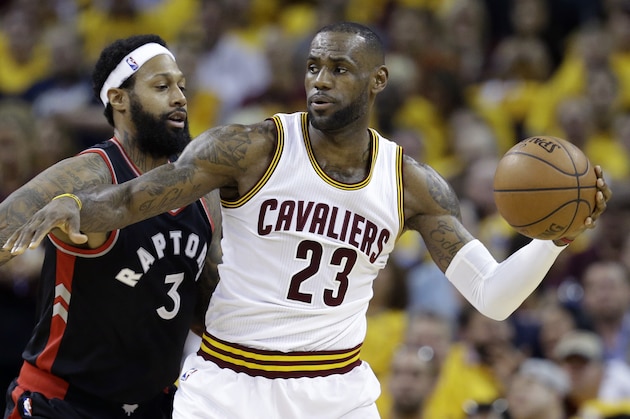 Cleveland Cavaliers' LeBron James (23) looks to pass against Toronto Raptors' James Johnson (3) during the first half of Game 5 of the NBA basketball Eastern Conference finals Wednesday, May 25, 2016, in Cleveland. (AP Photo/Tony Dejak)