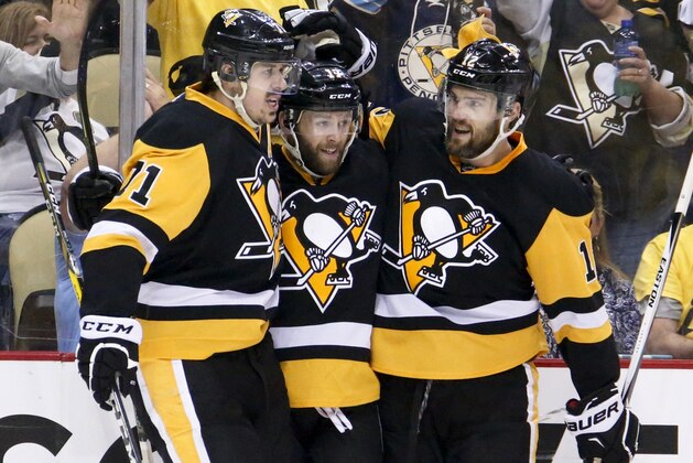 Pittsburgh Penguins' Bryan Rust, center is congratulated by teammates Evgeni Malkin, left, and Ben Lovejoy (12) after scoring against the Tampa Bay Lightning during the second period of Game 7 of the NHL hockey Stanley Cup Eastern Conference finals, Thursday, May 26, 2016, in Pittsburgh. (AP Photo/Gene J. Puskar)