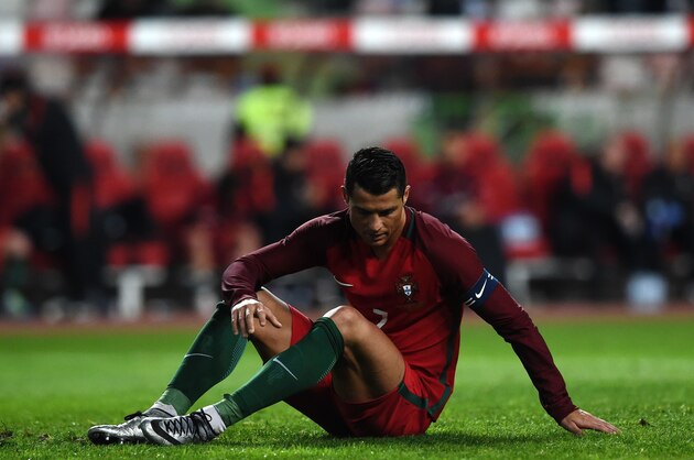 Portugal's forward Cristiano Ronaldo sits on the pitch as he reacts after failing to score a penalty kick during the EURO 2016 friendly football match Portugal vs Bulgaria at Magalhaes Pessoa stadium in Leiria on March 25, 2016. / AFP / FRANCISCO LEONG        (Photo credit should read FRANCISCO LEONG/AFP/Getty Images)