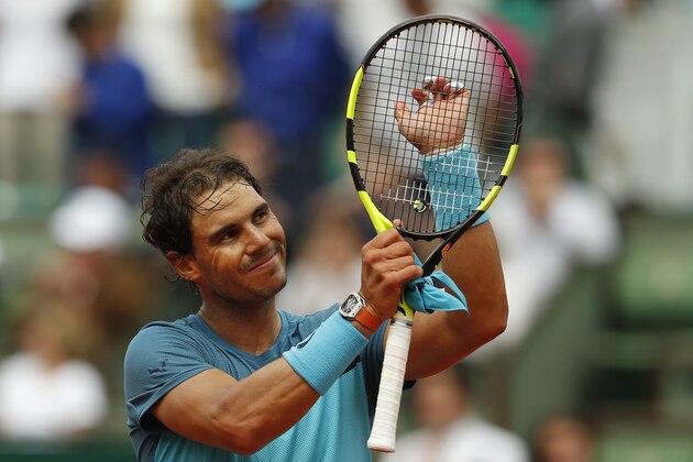 Spain's Rafael Nadal acknowledges cheering spectators after winning his second round match of the French Open tennis tournament against Argentina's Facundo Bagnis at the Roland Garros stadium in Paris, France, Thursday, May 26, 2016. (AP Photo/Alastair Grant)