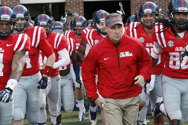FILE - In this Oct. 19, 2013, file photo, Mississippi football coach Hugh Freeze leads his team to the field prior to their NCAA college football game against LSU  in Oxford, Miss. Mississippi has aspirations of competing for SEC titles. No. 11 Ole Miss (4-0, 1-0) plays No. 3 Alabama (4-0, 1-0) on Saturday, Oct. 4, 2014,  in its biggest home game in more than a decade.  (AP Photo/Rogelio V. Solis, File)