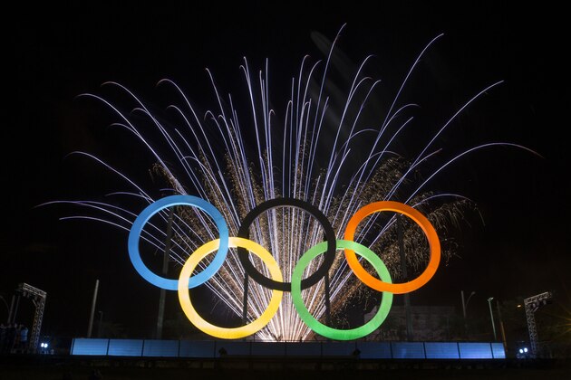 FILE - In this May 20, 2015 file photo, fireworks explode behind the Olympic rings during their inauguration ceremony at Madureira Park in Rio de Janeiro, Brazil. Some people in Brazil are trying to scalp tickets for the Rio de Janeiro Olympics, even before the tickets are issued. Rio de Janeiro Police Investigator Gilberto Ribeiro said on Tuesday, April 5, 2016 that 10 people have been detected using social media trying to sell ticket vouchers, to be exchanged for tickets, at up to double their face value. (AP Photo/Felipe Dana, File)