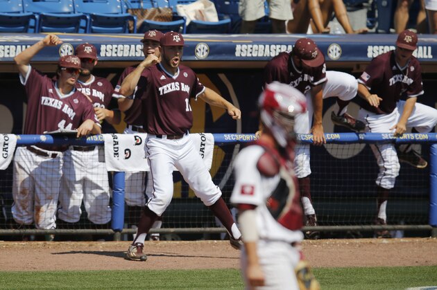 Texas A&M Corbin Martin, center, celebrates with his teammates outside of the dugout after Texas A&M scored against South Carolina in the second inning at the Southeastern Conference NCAA college baseball tournament at the Hoover Met, Thursday, May 26, 2016, in Hoover, Ala. (AP Photo/Brynn Anderson)