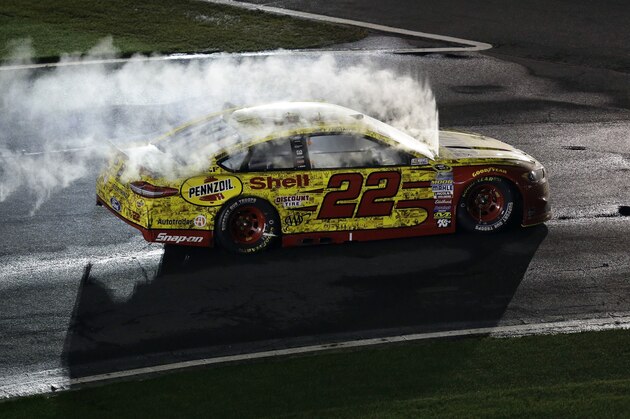 Joey Logano drives his car to Victory Lane after he won the NASCAR All-Star auto race at Charlotte Motor Speedway in Concord, N.C., Saturday, May 21, 2016. (AP Photo/Gerry Broome)