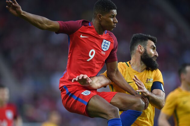 England's striker Marcus Rashford (L) vies for the ball against Australia's Mile Jedinak during the friendly football match between England and Australia at the Stadium of Light in Sunderland, north east England, on May 27, 2016. / AFP / PAUL ELLIS / NOT FOR MARKETING OR ADVERTISING USE / RESTRICTED TO EDITORIAL USE        (Photo credit should read PAUL ELLIS/AFP/Getty Images)