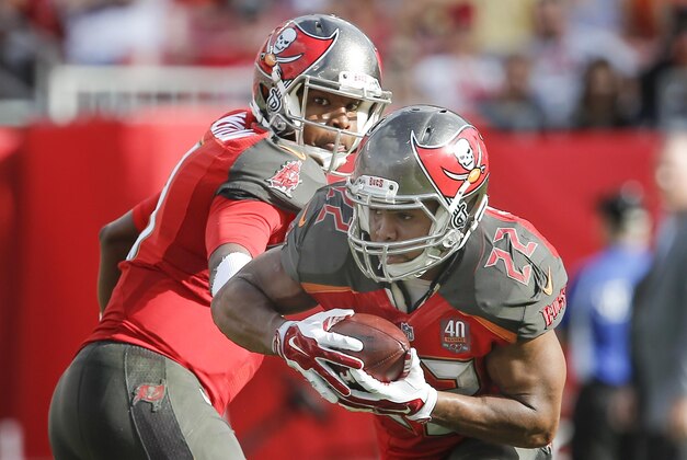 Dec 27, 2015; Tampa, FL, USA; Tampa Bay Buccaneers running back Doug Martin (22) takes a handoff from Tampa Bay Buccaneers quarterback Jameis Winston during the second half of a football game at Raymond James Stadium. The Bears won 26-12. Mandatory Credit: Reinhold Matay-USA TODAY Sports