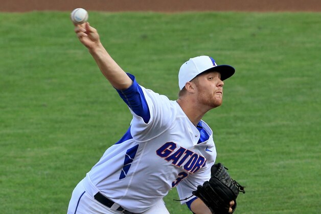 FILE - In this June 13, 2015 file photo, Florida starting pitcher Logan Shore throws during an NCAA College World Series baseball game against Miami in Omaha, Neb. Shore and fellow pitchers A.J. Puk and Alex Faedo are an imposing weekend rotation that combined for a 26-11 record last season. (AP Photo/Nati Harnik, file)