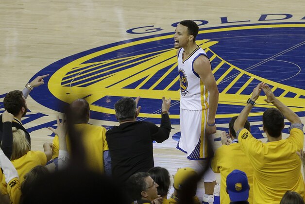 Fans cheer as Golden State Warriors guard Stephen Curry (30) reacts after scoring during the second half of Game 5 of the NBA basketball Western Conference finals against the Oklahoma City Thunder in Oakland, Calif., Thursday, May 26, 2016. The Warriors won 120-111. (AP Photo/Jeff Chiu)