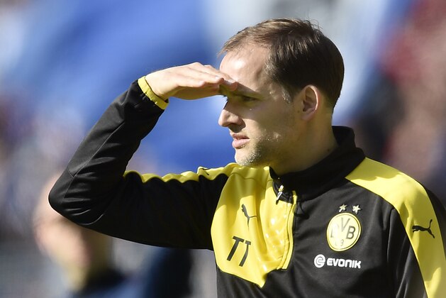 Dortmund head coach Thomas Tuchel watches the pitch against the sun during the German Bundesliga soccer match between Borussia Dortmund and Hamburger SV in Dortmund, Germany, Sunday, April 17, 2016. (AP Photo/Martin Meissner)