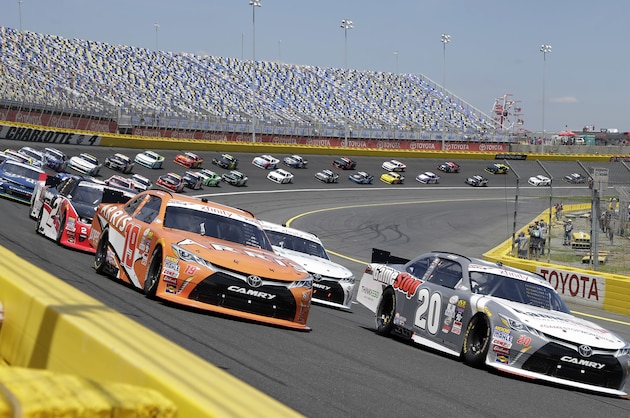 Erik Jones (20) and Daniel Suarez (19) lead the field out of Turn 4 for the start of the NASCAR Xfinity series auto race at Charlotte Motor Speedway in Concord, N.C., Saturday, May 28, 2016. (AP Photo/Chuck Burton)
