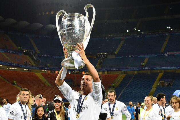 Real Madrid's Portuguese forward Cristiano Ronaldo lifts the trophy after Real Madrid won the UEFA Champions League final football match over Atletico Madrid at San Siro Stadium in Milan, on May 28, 2016. / AFP / GERARD JULIEN        (Photo credit should read GERARD JULIEN/AFP/Getty Images)
