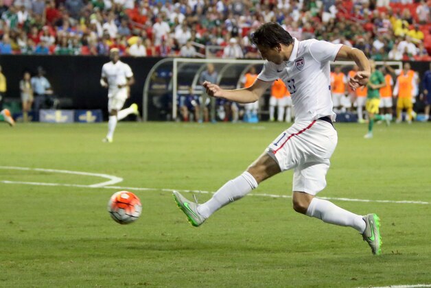 Jul 22, 2015; Atlanta, GA, USA; United States midfielder Alejandro Bedoya (11) takes a shot on goal against Jamaica int he first half during the CONCACAF Gold Cup semifinal match at Georgia Dome. Mandatory Credit: Jason Getz-USA TODAY Sports