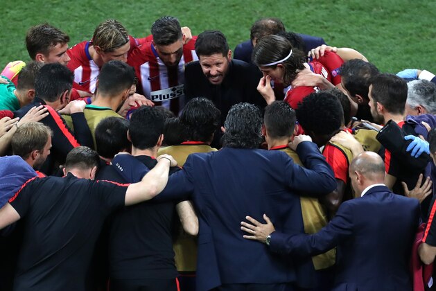 Atletico's coach Diego Simeone, center, speaks to his players before extra time during the Champions League final soccer match between Real Madrid and Atletico Madrid at the San Siro stadium in Milan, Italy, Saturday, May 28, 2016.  (AP Photo/Alessandra Tarantino)