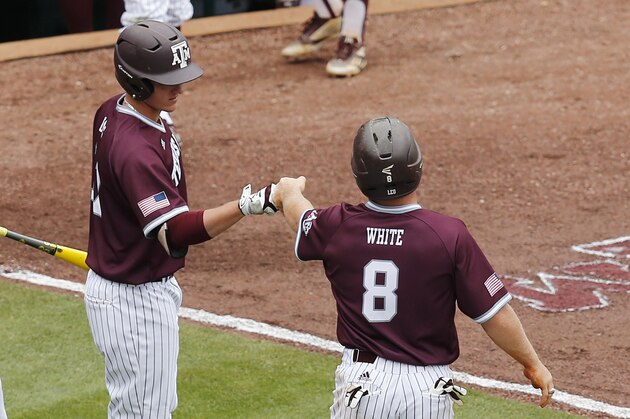 Texas A&M Joel Davis, left, fist bumps Boomer White, right, after White scores during the first inning of an NCAA college baseball game against Mississippi in the Southeastern Conference tournament at the Hoover Met, Saturday, May 28, 2016, in Hoover, Ala. (AP Photo/Brynn Anderson)