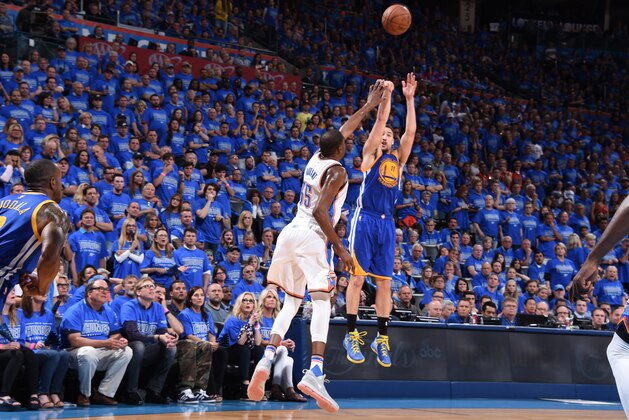 OKLAHOMA CITY, OK - MAY 28:  Klay Thompson #11 of the Golden State Warriors shoots against Kevin Durant #35 of the Oklahoma City Thunder in Game Six of the Western Conference Finals during the 2016 NBA Playoffs on May 28, 2016 at Chesapeake Energy Arena in Oklahoma City, Oklahoma. NOTE TO USER: User expressly acknowledges and agrees that, by downloading and or using this photograph, User is consenting to the terms and conditions of the Getty Images License Agreement. Mandatory Copyright Notice: Copyright 2016 NBAE (Photo by Andrew D. Bernstein/NBAE via Getty Images)