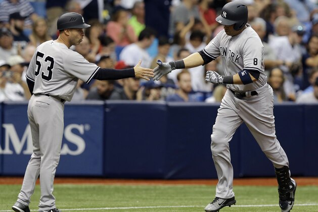 New York Yankees' Carlos Beltran, right, shakes hands with third base coach Joe Espada after his home run off Tampa Bay Rays starting pitcher Matt Moore during the fourth inning of a baseball game, Saturday, May 28, 2016, in St. Petersburg, Fla. (AP Photo/Chris O'Meara)