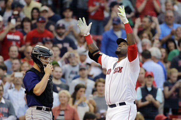 Boston Red Sox designated hitter David Ortiz celebrates his two-run home run, in front of Colorado Rockies catcher Dustin Garneau during the first inning of a baseball game at Fenway Park, Thursday, May 26, 2016, in Boston. (AP Photo/Elise Amendola)
