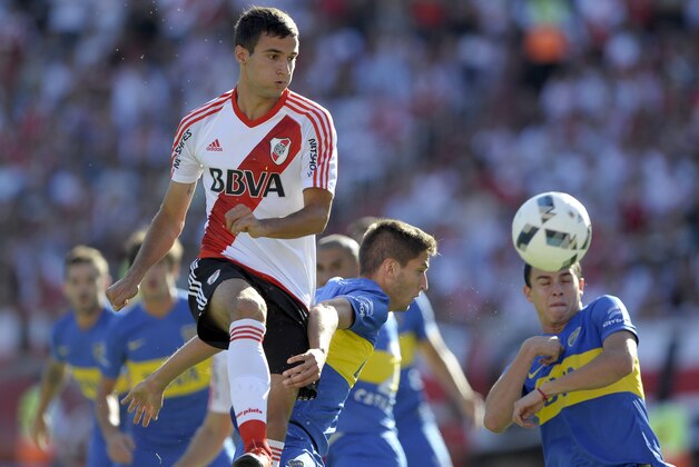 River Plate's defender Emanuel Mammana (R) heads the  ball with past Boca Juniors' midfielder Rodrigo Bentancur (C) and defender Leonardo Jara during their Argentina First Division football match at the Monumental stadium, in Buenos Aires, on March 6, 2016. AFP PHOTO / ALEJANDRO PAGNI / AFP / ALEJANDRO PAGNI        (Photo credit should read ALEJANDRO PAGNI/AFP/Getty Images)