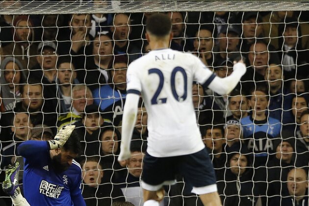 West Brom’s Craig Dawson, on the ground right, scores an own goal through West Brom’s goalkeeper Boaz Myhill legs as Tottenham Hotspur’s Jan Vertonghen falls during their English Premier League soccer match between Tottenham Hotspur and West Bromwich Albion at White Hart Lane in London, Monday, April, 25,  2016. (AP Photo/Alastair Grant)