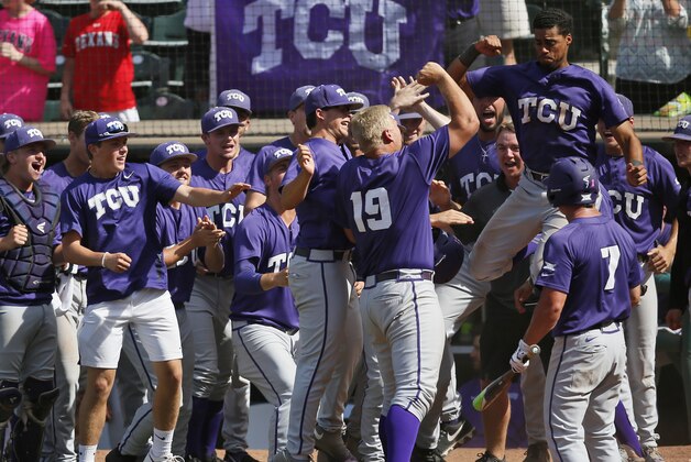 TCU infielder Luken Baker (19) celebrates his solo home run with his teammates in the tenth inning against West Virginia in the championship game of the NCAA college Big 12 conference baseball tournament in Oklahoma City, Sunday, May 29, 2016. TCU won 11-10 in ten innings. (AP Photo/Sue Ogrocki)