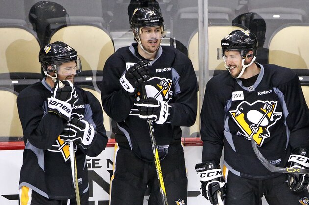 Pittsburgh Penguins' Chris Kunitz, left, Evgeni Malkin (71) and Sidney Crosby (87) wait to run a drill during hockey practice at the Consol Energy Center in Pittsburgh, Sunday May 29, 2016. The Penguins are preparing for Game 1 of the Stanley Cup Finals against the San Jose Sharks on Monday, May 30, in Pittsburgh. (AP Photo/Gene J. Puskar)