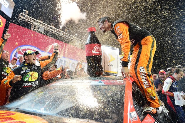 CHARLOTTE, NC - MAY 29: Martin Truex Jr., driver of the #78 Bass Pro Shops/Tracker Toyota, celebrates with champagne in Victory Lane after winning the NASCAR Sprint Cup Series Coca-Cola 600 at Charlotte Motor Speedway on May 29, 2016 in Charlotte, North Carolina.  (Photo by Jared C. Tilton/Getty Images)