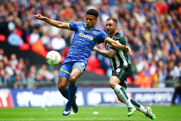 LONDON, ENGLAND - MAY 30:  Lyle Taylor of Wimbledon tackles with Carl McHugh of Plymouth during the Sky Bet League Two Play Off Final match between Plymouth Argyle and AFC Wimbledon at Wembley Stadium on May 30, 2016 in London, England.  (Photo by Jordan Mansfield/Getty Images)