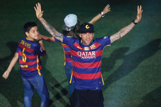Barcelona's Brazilian defender Dani Alves acknowledges the crowd during celebrations at the Camp Nou stadium in Barcelona on May 23, 2016 following their Spanish 'Copa del Rey' (King's Cup) final football match 2-0 victory over Sevilla FC yesterday also marking the club's 28th Copa del Rey win and the 24th Spanish Liga title. / AFP / PAU BARRENA        (Photo credit should read PAU BARRENA/AFP/Getty Images)