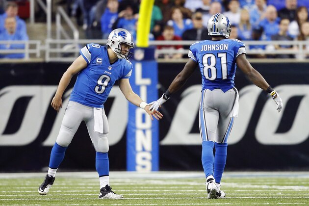 Detroit Lions wide receiver Calvin Johnson (81) is congratulated by teammate quarterback Matthew Stafford (9) after a 7-yard reception during the second quarter of an NFL football game in Detroit, Monday, Dec. 16, 2013. With the catch, Johnson becomes the first player in NFL history to record 5,000 yards in any three-season span. (AP Photo/Rick Osentoski)