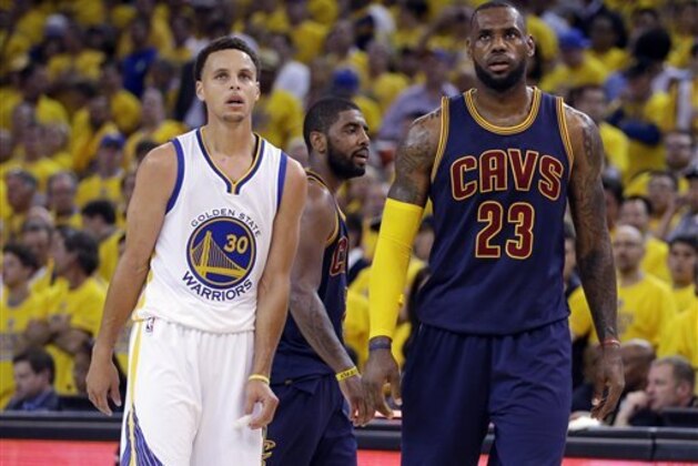 Golden State Warriors guard Stephen Curry (30) and Cleveland Cavaliers forward LeBron James (23) walk on the floor during the second half of Game 1 of basketball's NBA Finals in Oakland, Calif., Thursday, June 4, 2015. (AP Photo/Ben Margot)