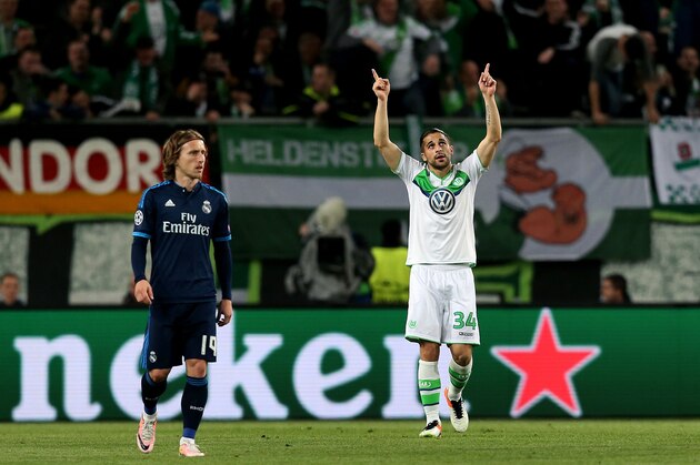 Wolfsburg's Swiss defender Ricardo Rodriguez reacts past Real Madrid's Croatian midfielder Luka Modric (L) vie for the ball during the UEFA Champions League quarter-final, first-leg football match between VfL Wolfsburg and Real Madrid on April 6, 2016 in Wolfsburg, northern Germany.  / AFP / Ronny Hartmann        (Photo credit should read RONNY HARTMANN/AFP/Getty Images)