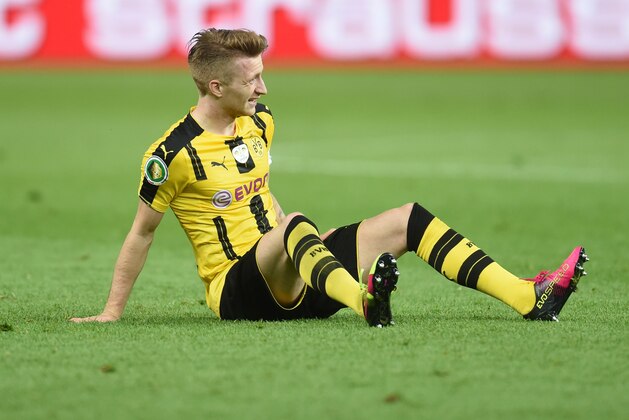 Dortmund's midfielder Marca Reus sits at the field during the German Cup (DFB Pokal) final football match Bayern Munich vs Borussia Dortmund at the Olympic stadium in Berlin on May 21, 2016. / AFP / CHRISTOF STACHE / RESTRICTIONS: ACCORDING TO DFB RULES IMAGE SEQUENCES TO SIMULATE VIDEO IS NOT ALLOWED DURING MATCH TIME. MOBILE (MMS) USE IS NOT ALLOWED DURING AND FOR FURTHER TWO HOURS AFTER THE MATCH. == RESTRICTED TO EDITORIAL USE == FOR MORE INFORMATION CONTACT DFB DIRECTLY AT +49 69 67880

 /         (Photo credit should read CHRISTOF STACHE/AFP/Getty Images)