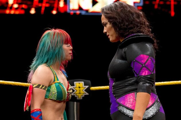 Nia Jax and Asuka stare each other down.