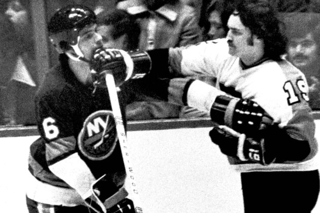 Rick MacLeish (19) of the Flyers gets a jab across at Bert Marshal (6) of the New York Islanders while Marshall grabs for MacLeish in the first period of game at night, Thursday, April 4, 1974 in Philadelphia. (AP Photo/Rusty Kennedy) Rick MacLeish (19) of the Flyers gets a jab across at Bert Marshal (6) of the New York Islanders while Marshall grabs for MacLeish in the first period of game at night, Thursday, April 4, 1974 in Philadelphia. (AP Photo/Rusty Kennedy)