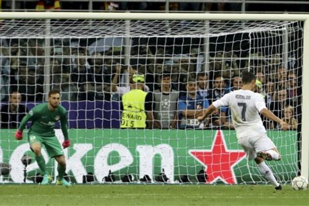 Real Madrid's Cristiano Ronaldo scores the decisive penalty kick during the Champions League final soccer match between Real Madrid and Atletico Madrid at the San Siro stadium in Milan, Italy, Saturday, May 28, 2016. Real Madrid won 5-3 on penalties after the match ended 1-1 after extra time.  (AP Photo/Luca Bruno)
