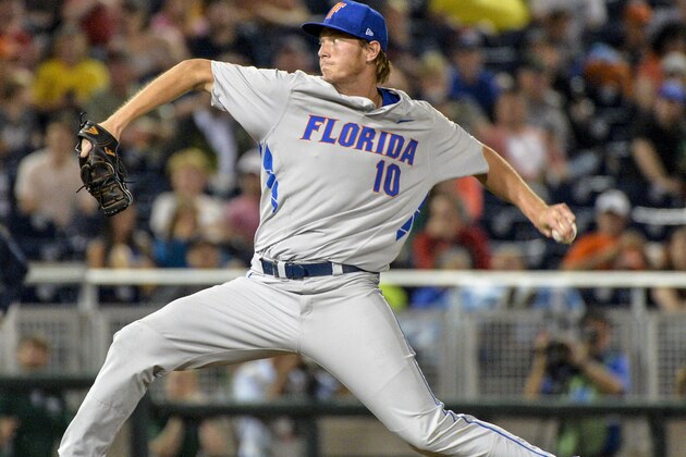 Florida starting pitcher A.J. Puk delivers against Virginia during the first inning of an NCAA College World Series baseball game in Omaha, Neb., Monday, June 15, 2015. (AP Photo/Ted Kirk)