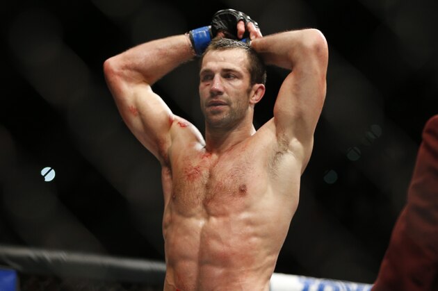 Luke Rockhold rests between rounds as he fights Chris Weidman in a middleweight  championship mixed martial arts bout at UFC 194, Saturday, Dec. 12, 2015, in Las Vegas. (AP Photo/John Locher)