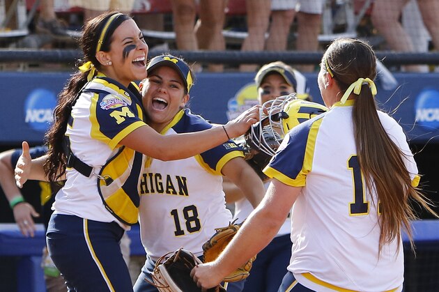 Michigan catcher Lauren Sweet, left, third baseman Lindsay Montemarano, center, and pitcher Kelsey Selman, right, celebrate after Michigan defeated LSU during an NCAA Women's College World Series game in Oklahoma City, Sunday, May 31, 2015. Michigan won 6-3 and moves on to the championship series. (AP Photo/Alonzo Adams)