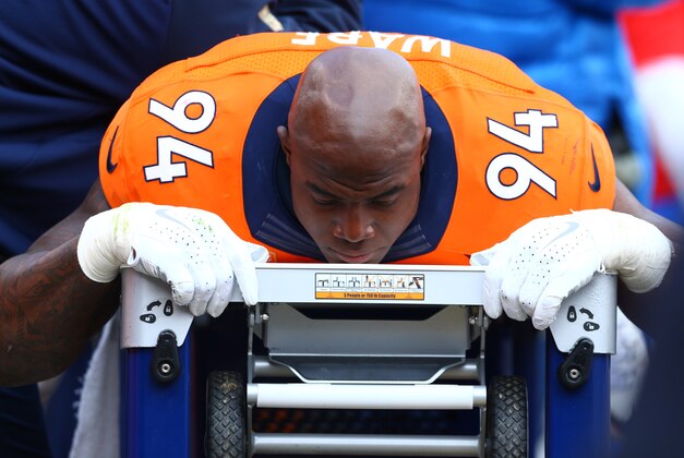 Jan 24, 2016; Denver, CO, USA; Denver Broncos defensive end DeMarcus Ware (94) lays on a table being tended to by a trainer on the sidelines against the New England Patriots in the AFC Championship football game at Sports Authority Field at Mile High. The Broncos defeated the Patriots 20-18 to advance to the Super Bowl. Mandatory Credit: Mark J. Rebilas-USA TODAY Sports